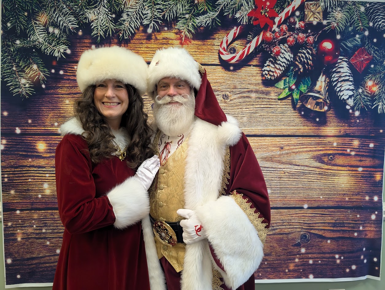 Santa and Mrs. Claus smiling together at a holiday celebration