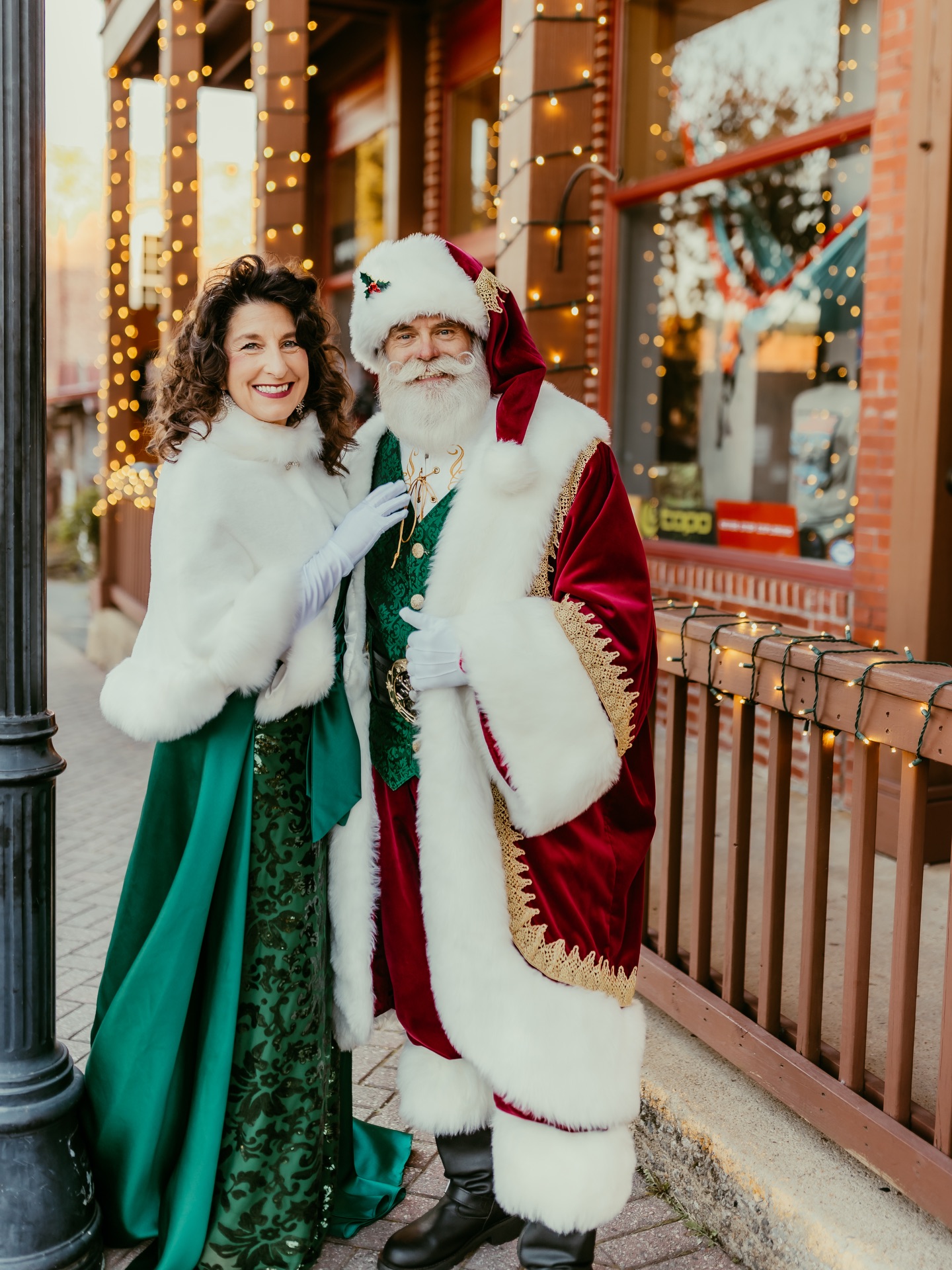 Santa and Mrs. Claus together on a decorated downtown street