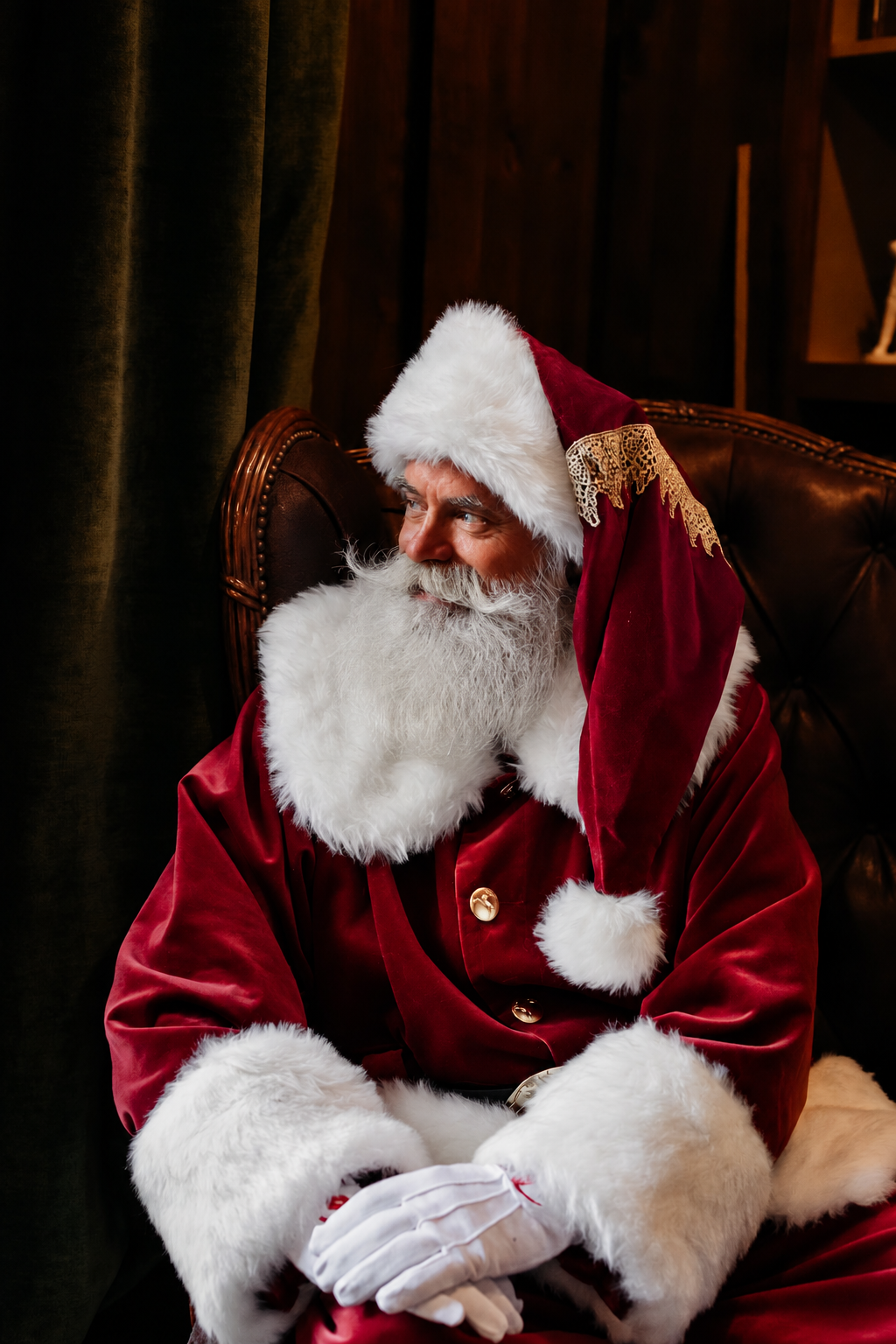 Santa seated in a classic leather chair